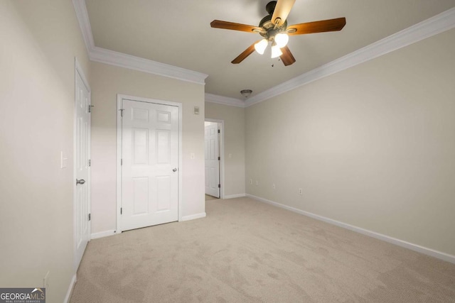 unfurnished bedroom featuring crown molding, ceiling fan, and light carpet