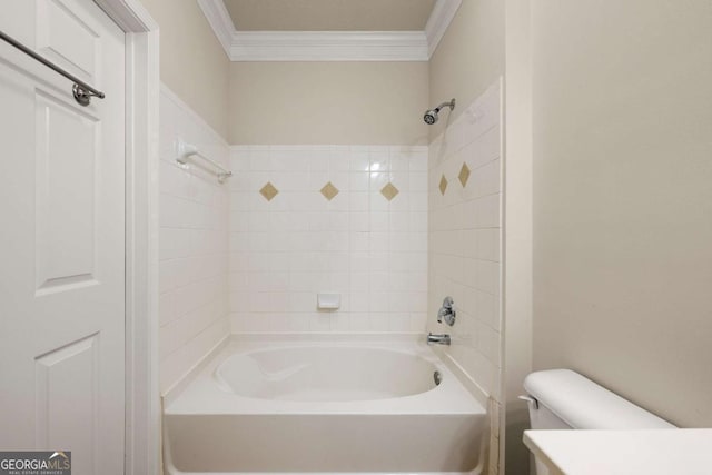 bathroom with tiled shower / bath combo, ornamental molding, and toilet