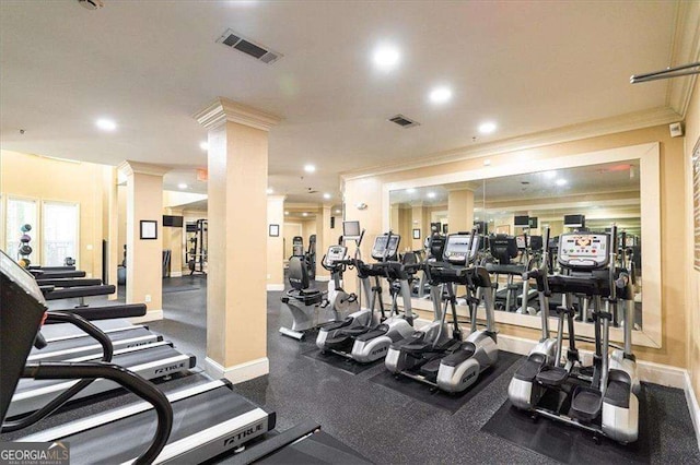 gym featuring ornamental molding and ornate columns