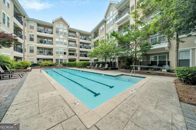 view of swimming pool with a patio area