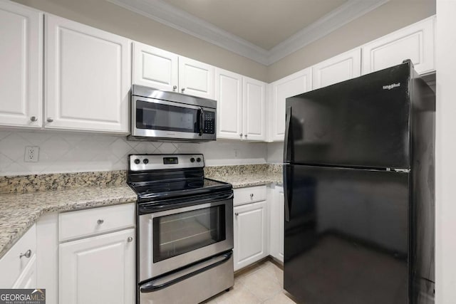 kitchen featuring light tile patterned flooring, ornamental molding, white cabinets, and appliances with stainless steel finishes