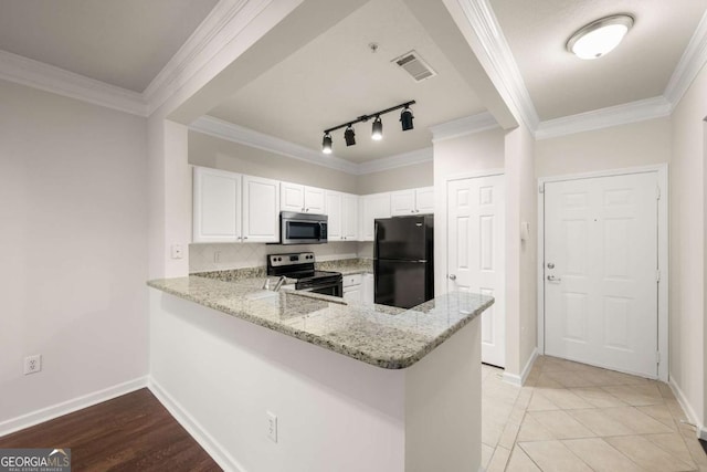 kitchen with appliances with stainless steel finishes, white cabinetry, light stone counters, kitchen peninsula, and crown molding