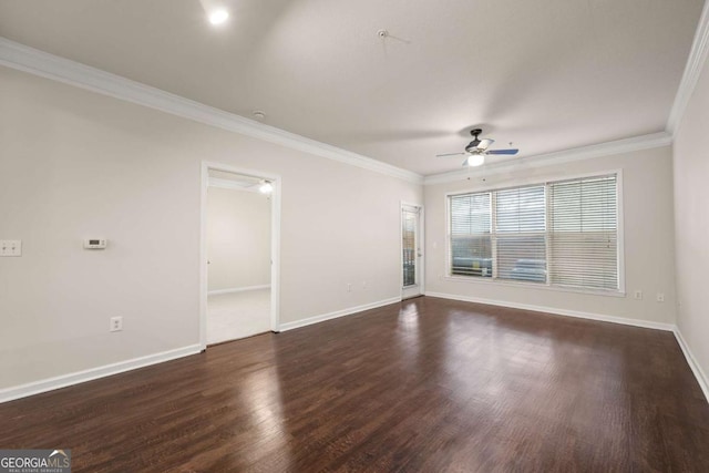 empty room with ornamental molding, dark hardwood / wood-style floors, and ceiling fan