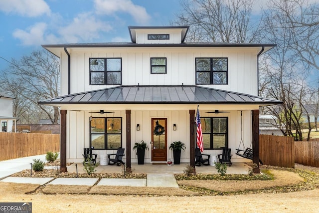 modern farmhouse with a ceiling fan, covered porch, and board and batten siding