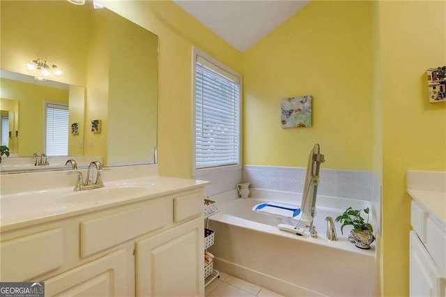 bathroom featuring vanity, lofted ceiling, a bath, and tile patterned floors