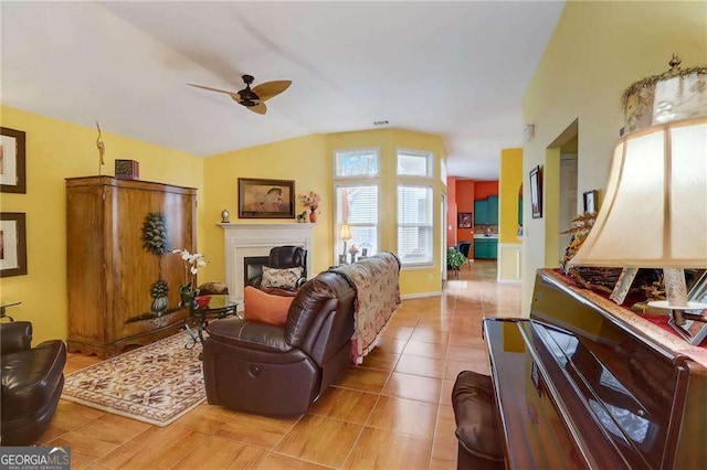 tiled living room featuring ceiling fan and lofted ceiling