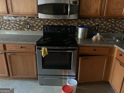 kitchen featuring stainless steel appliances and decorative backsplash