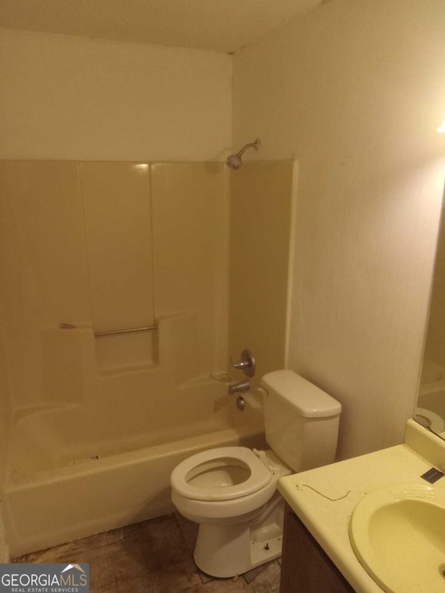 full bathroom featuring toilet, vanity, and bathtub / shower combination