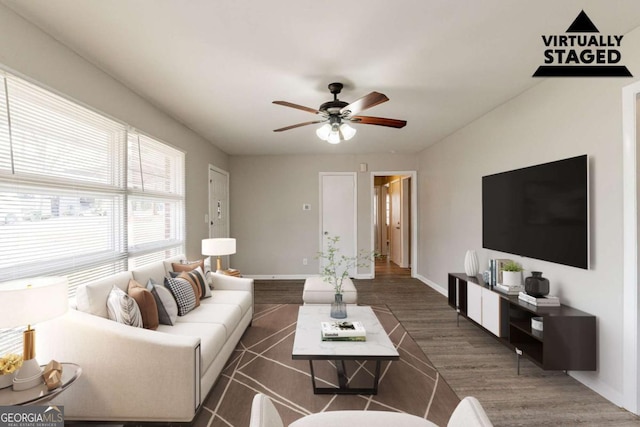 living room featuring dark wood-type flooring and ceiling fan