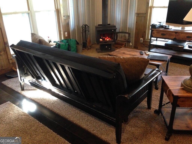 living room with wood-type flooring and a wood stove