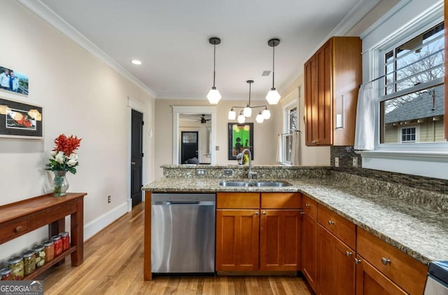 kitchen featuring stone countertops, sink, ornamental molding, stainless steel dishwasher, and kitchen peninsula