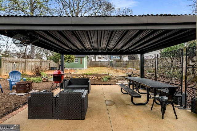 view of patio / terrace featuring an outdoor structure and a fire pit