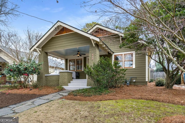 view of front of house featuring a front yard, ceiling fan, and a porch