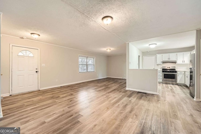 interior space with ornamental molding, light hardwood / wood-style flooring, and a textured ceiling