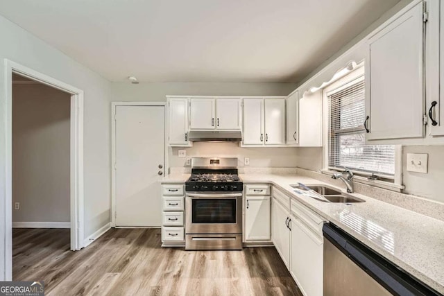 kitchen with sink, white cabinets, and appliances with stainless steel finishes