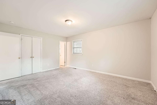 unfurnished bedroom featuring a closet and carpet flooring