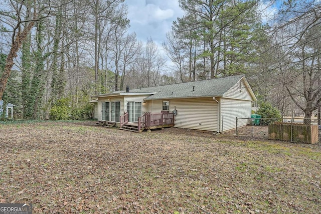 back of house with a deck