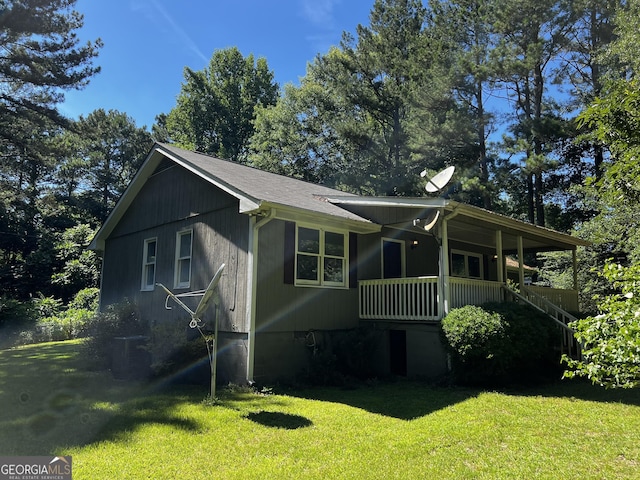 exterior space featuring covered porch and a lawn