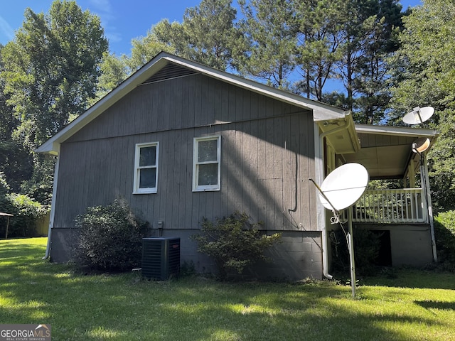 view of property exterior with cooling unit and a lawn