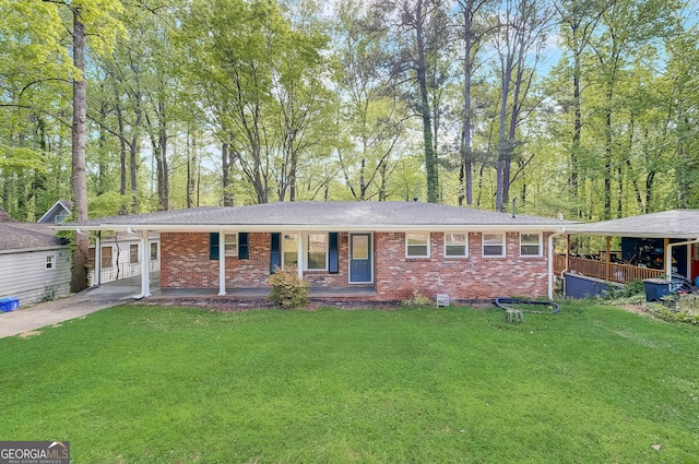 single story home with a carport, a porch, and a front lawn