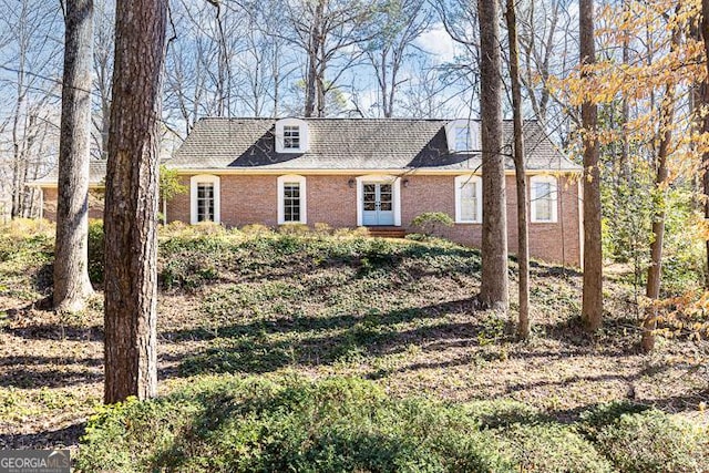 cape cod house with brick siding