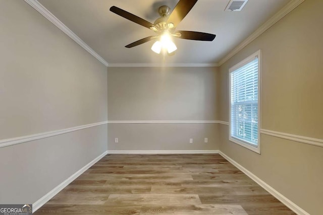 spare room featuring ceiling fan, ornamental molding, and light hardwood / wood-style floors