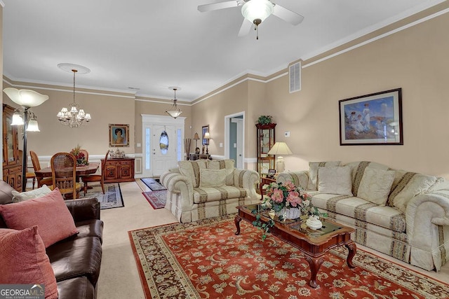 carpeted living room featuring crown molding and ceiling fan with notable chandelier