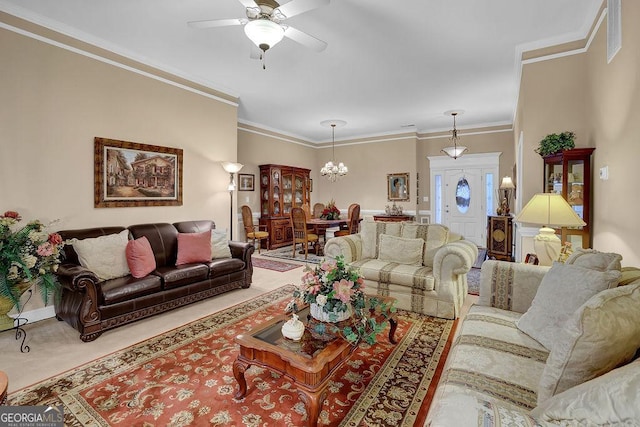 living room featuring carpet floors, crown molding, and ceiling fan with notable chandelier