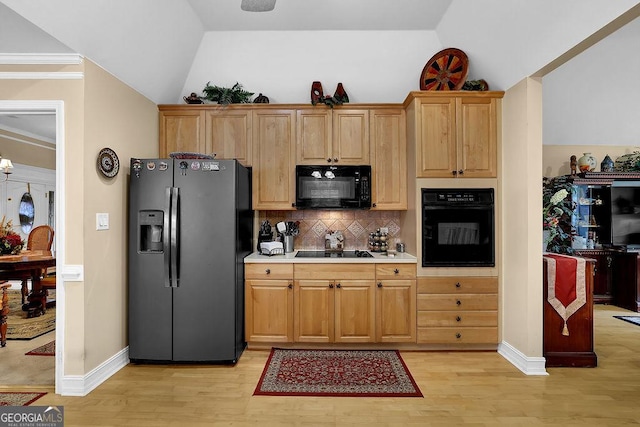 kitchen with backsplash, lofted ceiling, light hardwood / wood-style flooring, and black appliances