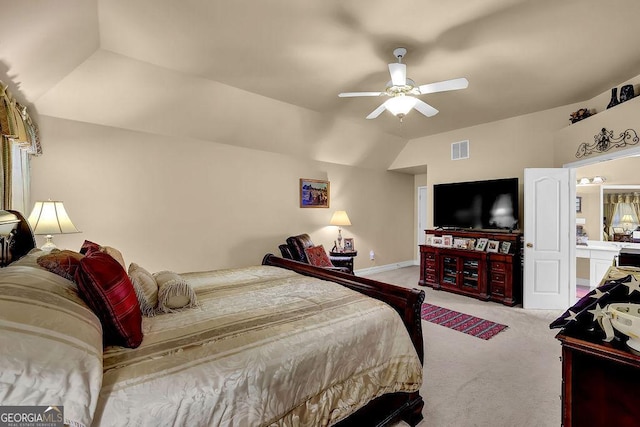 carpeted bedroom with ceiling fan and vaulted ceiling