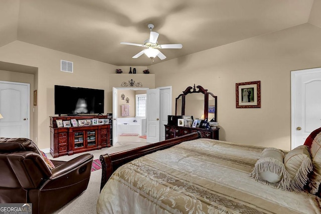 carpeted bedroom featuring vaulted ceiling, ceiling fan, and ensuite bath