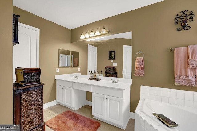 bathroom featuring a relaxing tiled tub, vanity, and tile patterned flooring