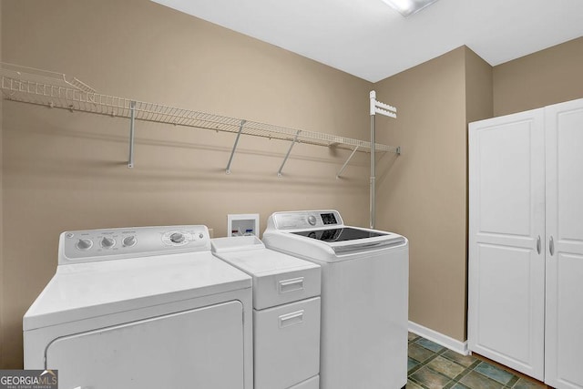 clothes washing area with washing machine and clothes dryer