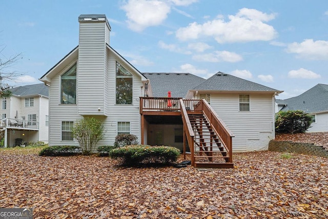 rear view of property featuring a wooden deck