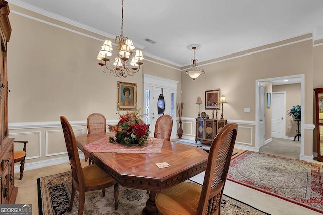 dining space with a notable chandelier and crown molding