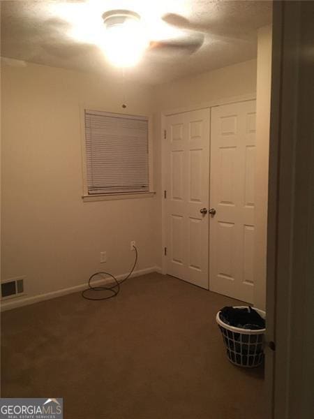 unfurnished bedroom with carpet floors and a closet