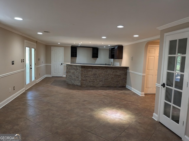 kitchen with ornamental molding, dark brown cabinets, and french doors