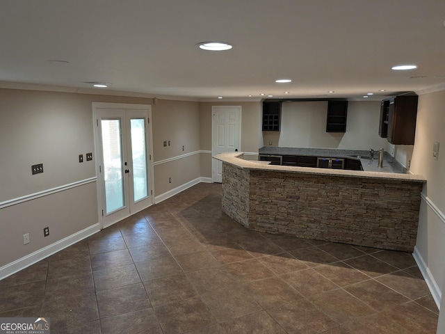 kitchen featuring sink, crown molding, french doors, and dark tile patterned floors