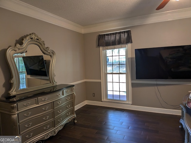 interior space with ceiling fan, ornamental molding, dark hardwood / wood-style flooring, and a textured ceiling