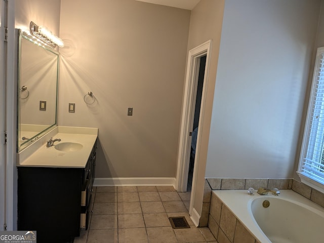 bathroom featuring vanity, tile patterned flooring, and a relaxing tiled tub