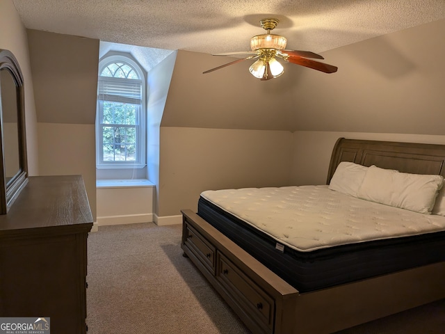 bedroom featuring ceiling fan, lofted ceiling, light carpet, and a textured ceiling