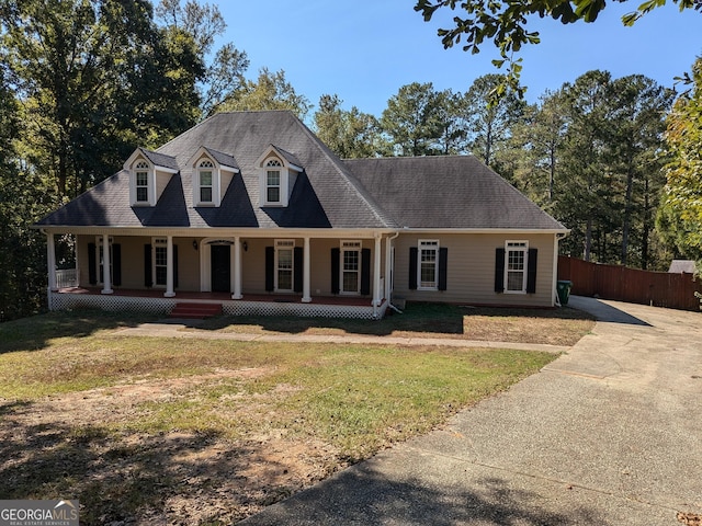 cape cod home featuring a front lawn and covered porch