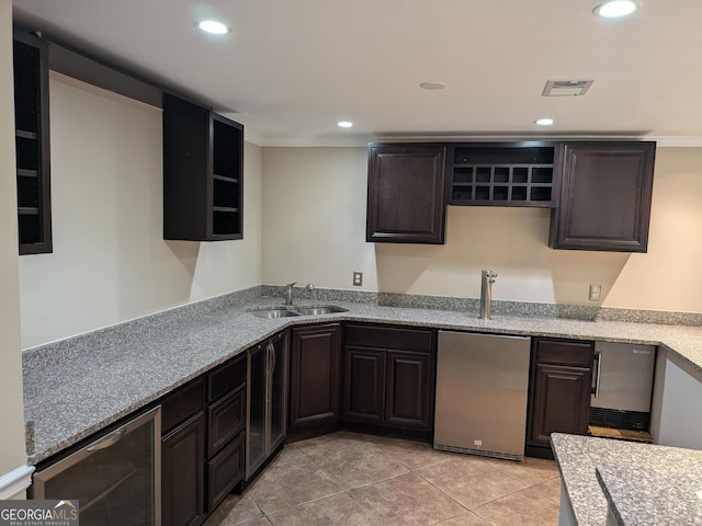 kitchen with wine cooler, sink, dark brown cabinets, and stainless steel fridge