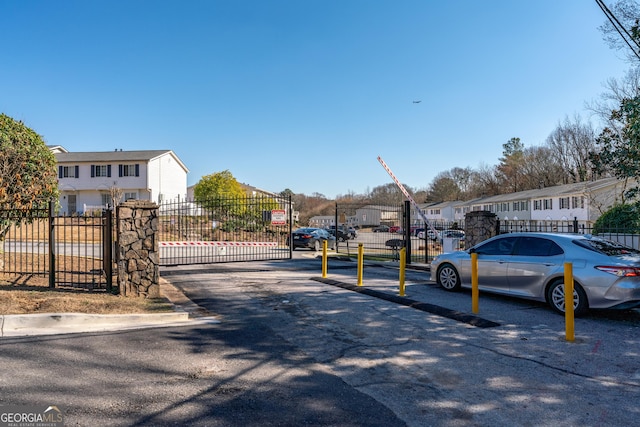 1625 Conley Rd Unit 270, Conley, GA 30288 - view of asphalt street featuring a residential view, a gated entry, curbs, and a gate