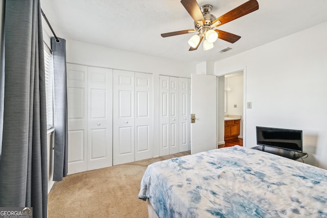 1625 Conley Rd Unit 270, Conley, GA 30288 - carpeted bedroom featuring two closets and a ceiling fan