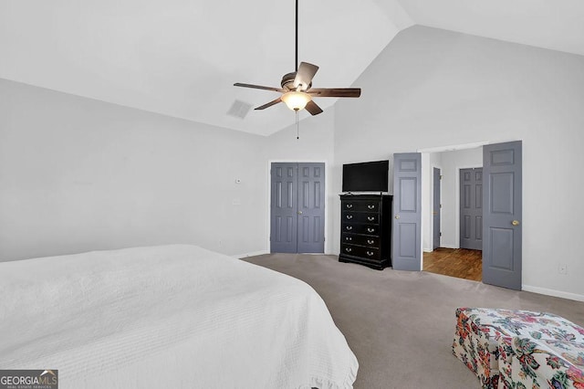 carpeted bedroom featuring ceiling fan, high vaulted ceiling, and a closet