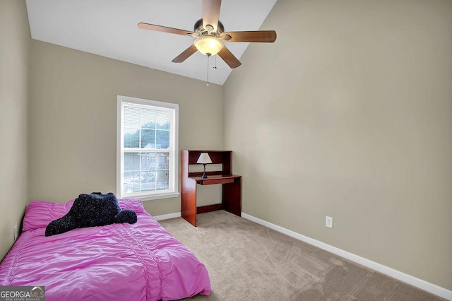 bedroom featuring vaulted ceiling, light colored carpet, and ceiling fan