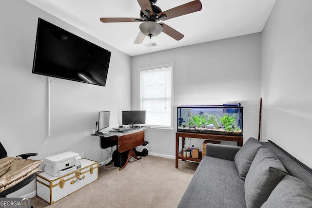 office space with light carpet and ceiling fan