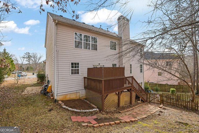 rear view of property with a wooden deck