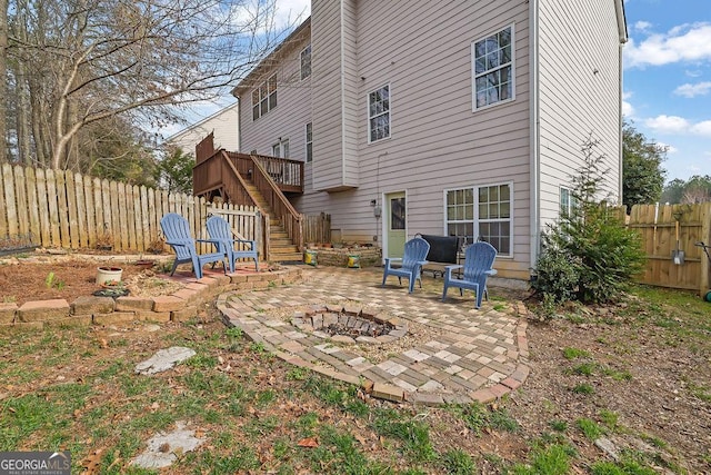 rear view of house with an outdoor fire pit and a patio